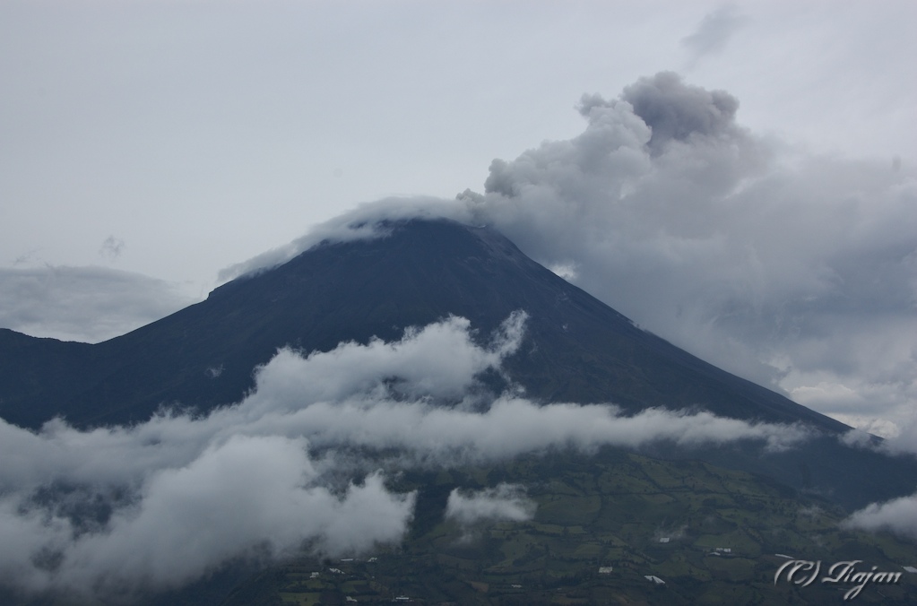 Tungurahua with its smoke and the low-lying clouds