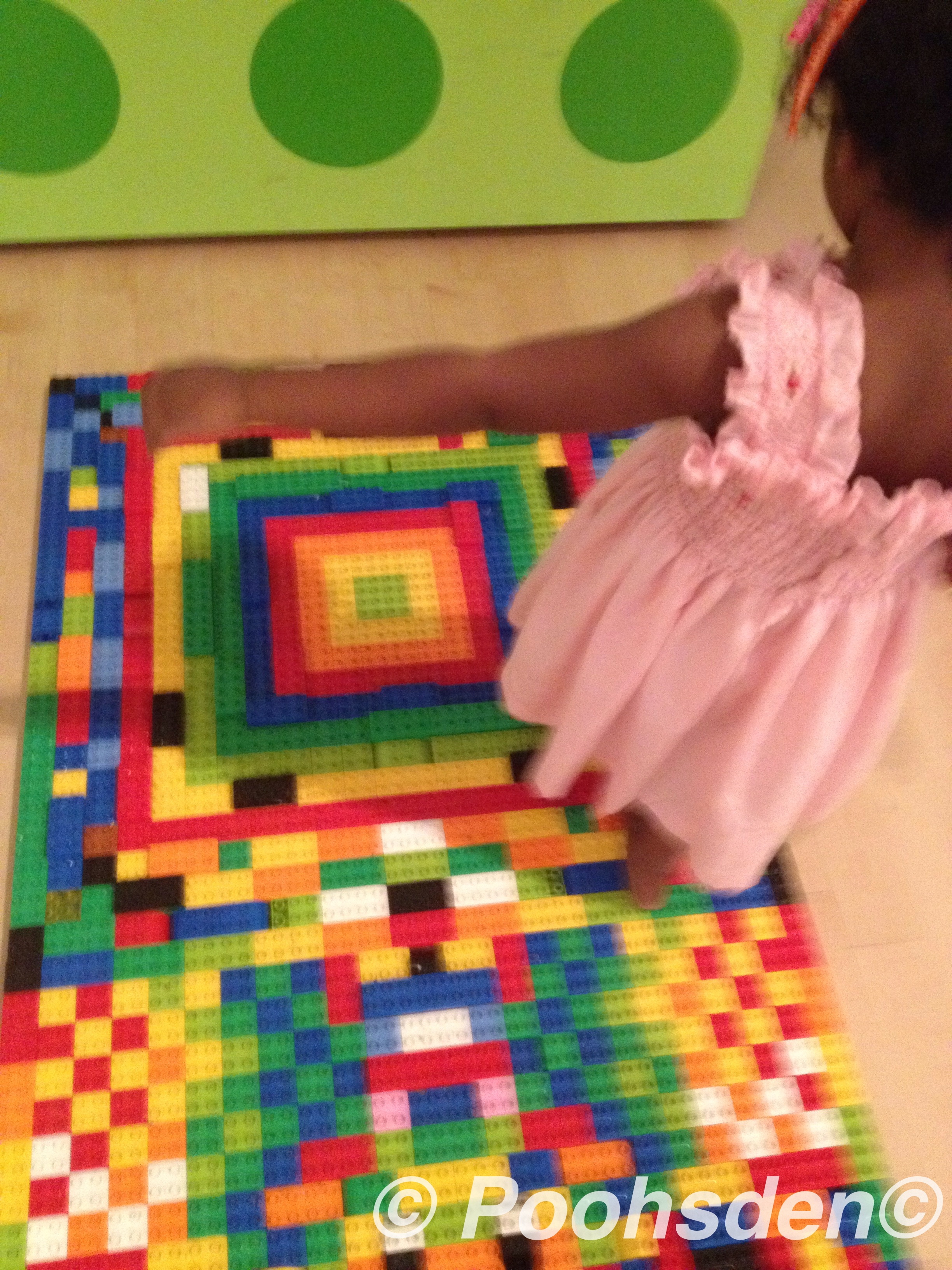 Kuttyma walking on a lego acupuncture mat at the Lego exhibit at the Art and Science Museum, Singapore